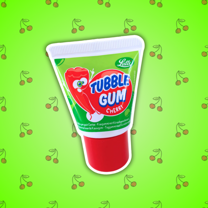 Image d'un tube imitation dentifrice avec un chewing-gum à l'intérieur goût cerise. Le tube est vert avec un bouchon rouge. Sur celui-ci on peut voir un petit bonhomme en forme de liquide de dentifrice qui fait une bulle pour rappeler le chewing-gum. Le tube est posé sur un fond vert fluo avec plein de cerises. 